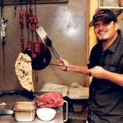 Suman Basnet pulls Garlic Naan ($3.50) out of the traditional tandoori clay oven at Himalayan Kitchen.