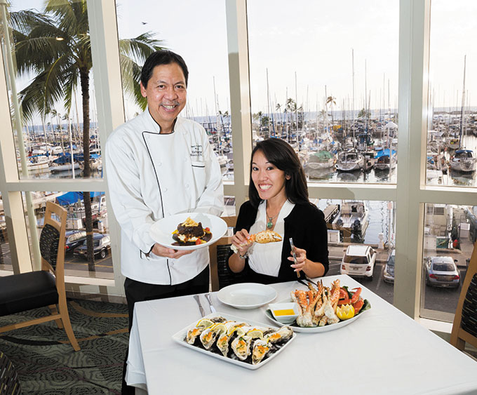 Executive chef Kirby Wong and Cara Sawai, account executive for catering sales, crack open top picks from the buffet and banquet menus.