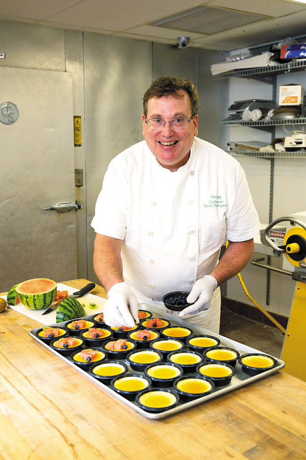 Chef and owner Niel Koep prepares a tray of Lychee Caramel Flan