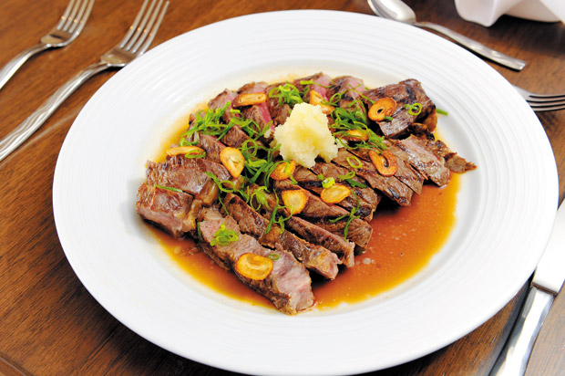 Wafu Steak is prepared with slices of top sirloin and ponzu butter sauce. 