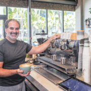 Island Brew Coffeehouse co-owner Rafael Baez with a warm cup of Joe.