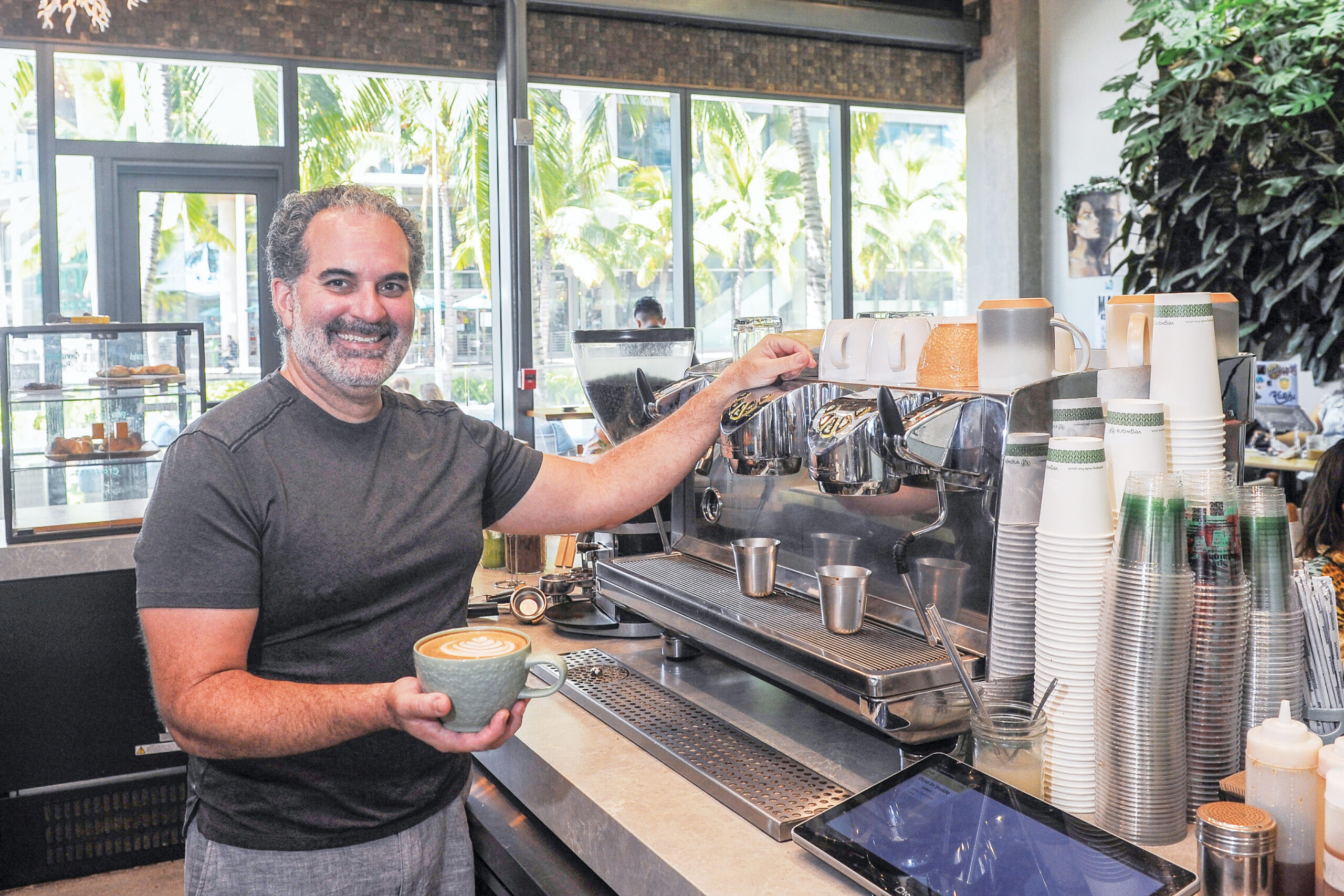 Island Brew Coffeehouse co-owner Rafael Baez with a warm cup of Joe.